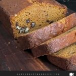Sweet potato bread sliced on a wooden board.