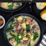 Sausage, potato and kale soup (Zuppa Toscana) in dark bowls on a dark surface.
