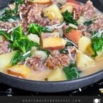 Sausage, potato and kale soup (Zuppa Toscana) in dark bowls on a dark surface.