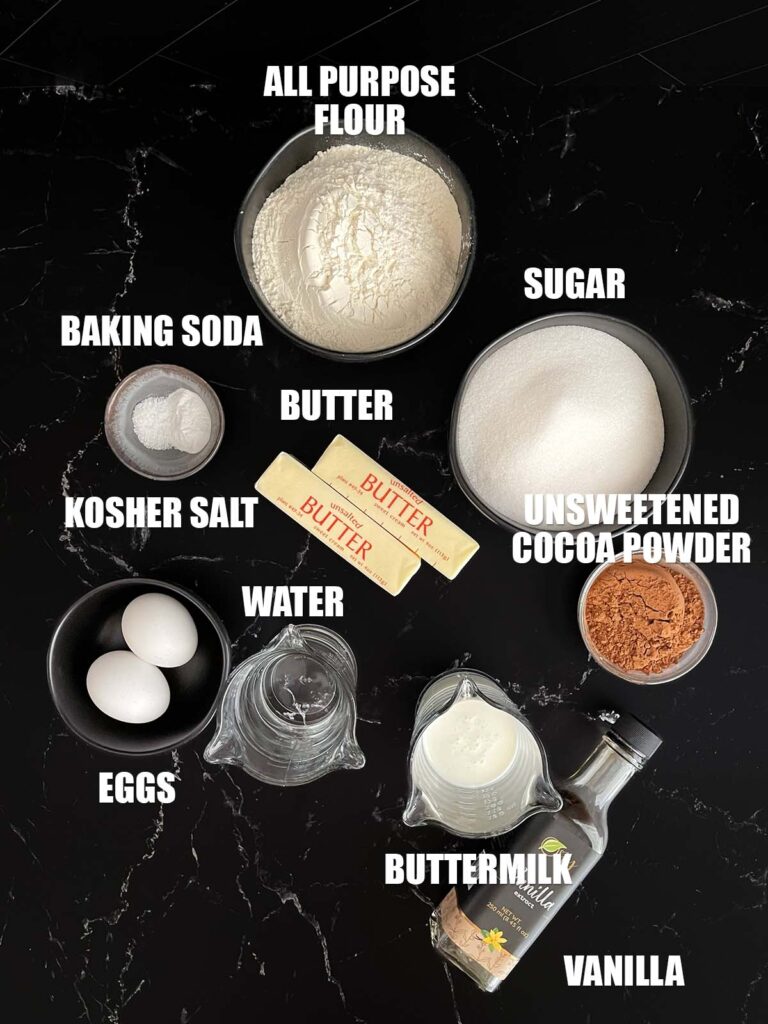 Buttermilk brownies recipe ingredients on a dark surface.