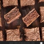 Sliced buttermilk brownies on a wooden cutting board.