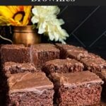 Sliced buttermilk brownies on a wooden cutting board.
