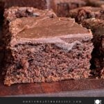 Sliced buttermilk brownies on a wooden cutting board.