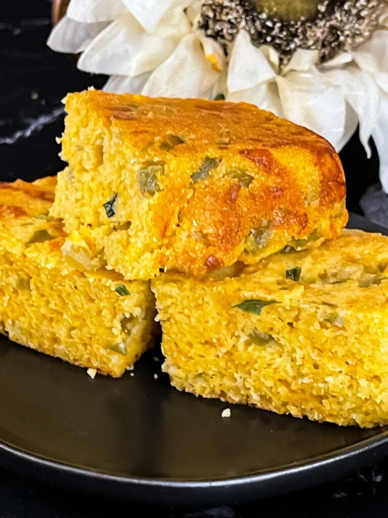 Cheddar jalapeno cornbread on a dark plate.