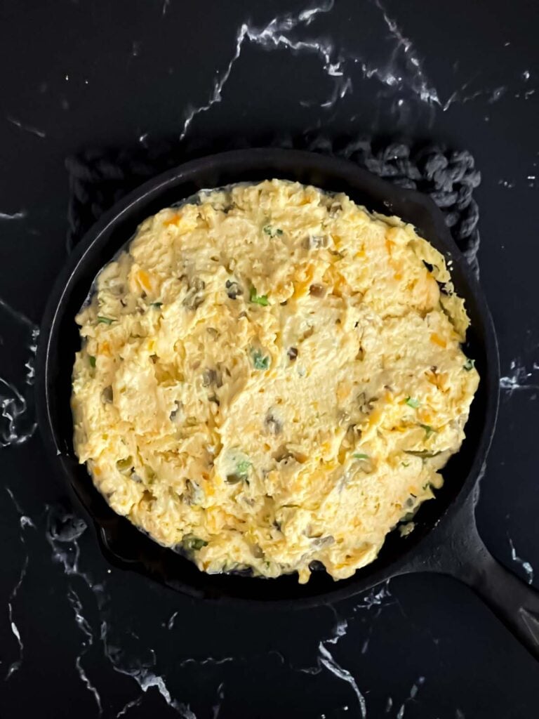 Cornbread batter in a cast iron skillet.