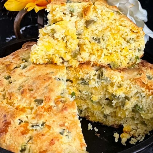 Cheddar jalapeno cornbread, cooked, in a cast iron skillet.