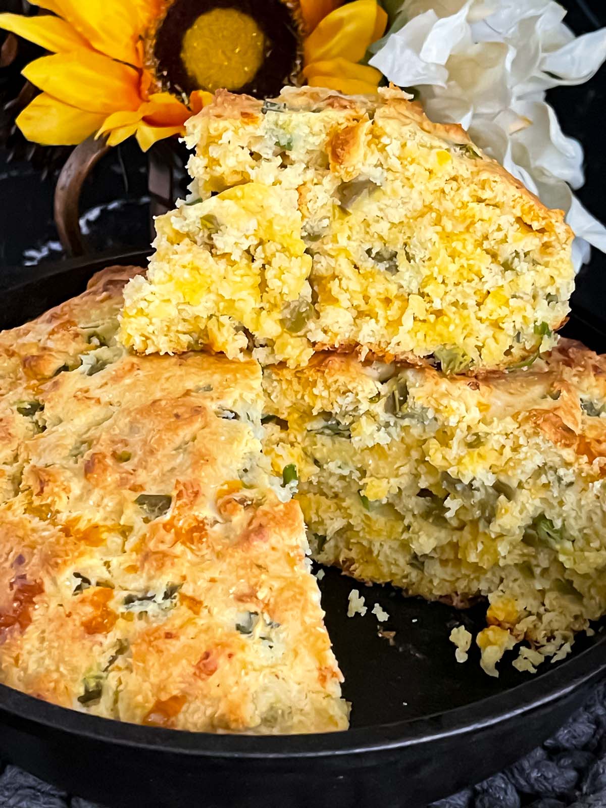 Cheddar jalapeno cornbread, cooked, in a cast iron skillet.