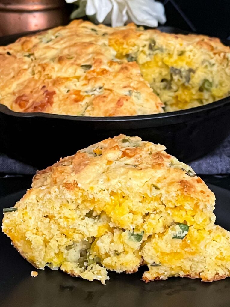Cheddar jalapeno cornbread, cooked, in a cast iron skillet.