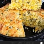 Cheddar jalapeno cornbread, cooked, in a cast iron skillet.