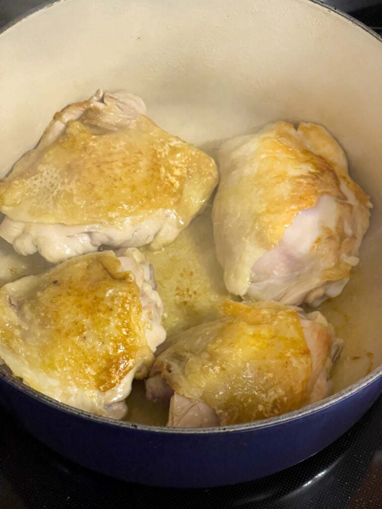Browned chicken thighs for the chicken noodle soup in a large dutch oven.