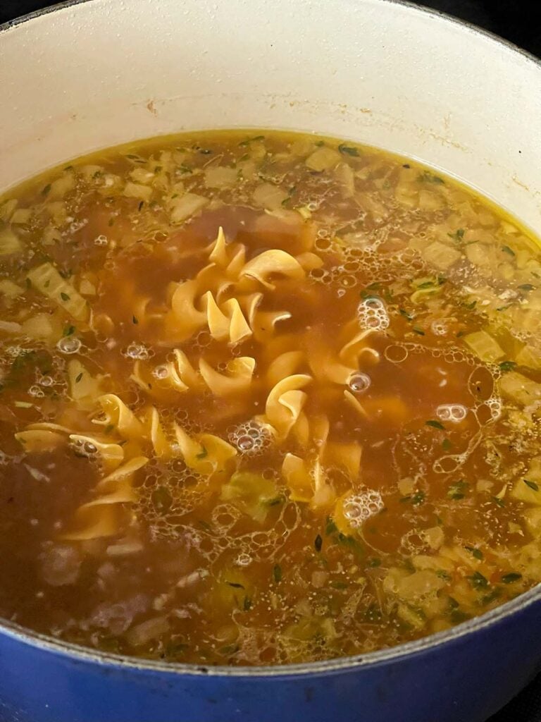 Extra wide egg noodles added to the chicken soup pot.