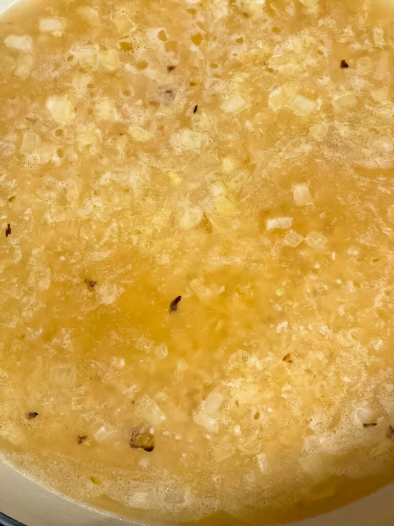 Vegetable stock added to the rice and onions for the cilantro lime rice recipe.
