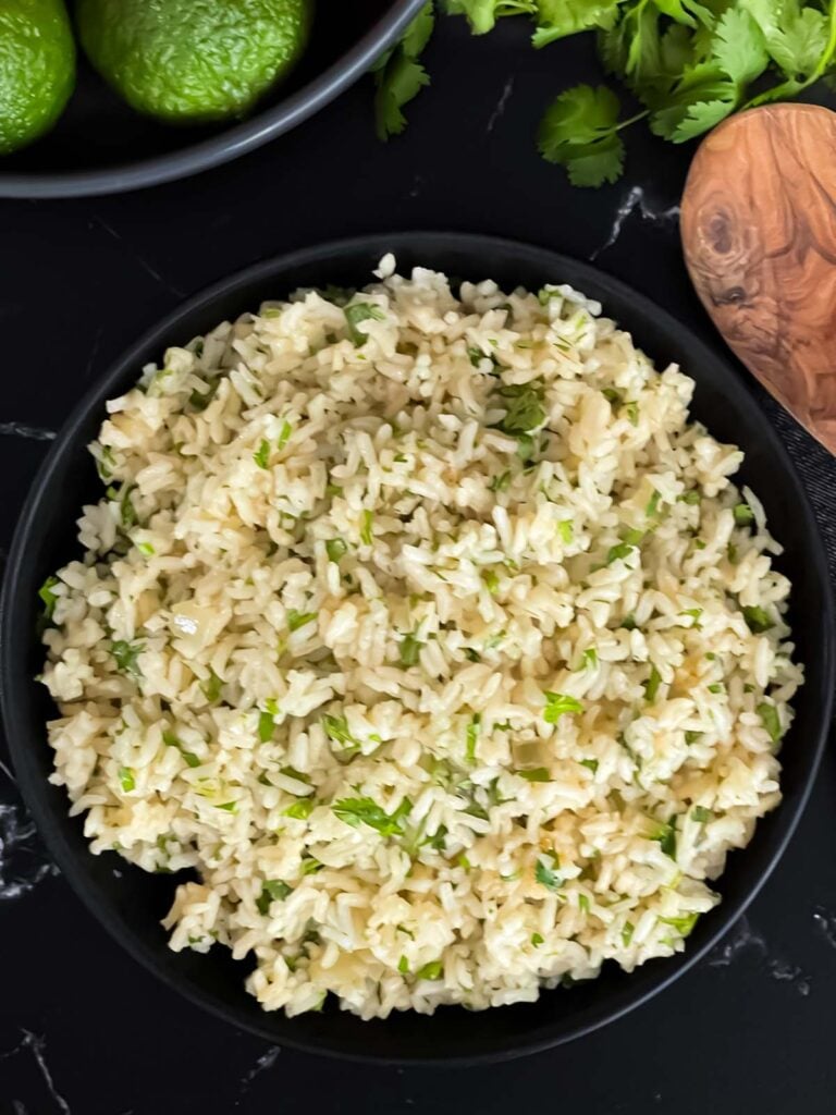 Cilantro lime rice in a dark bowl.