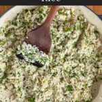 Cilantro lime rice in a dark bowl on a dark surface.