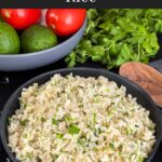 Cilantro lime rice in a dark bowl on a dark surface.