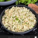 Cilantro lime rice in a dark bowl on a dark surface.