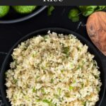 Cilantro lime rice in a dark bowl on a dark surface.