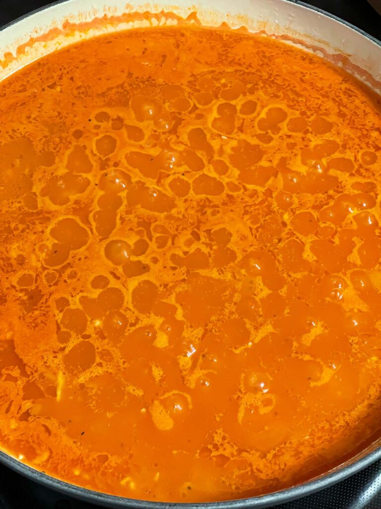 Mexican red rice cooking in a skillet.
