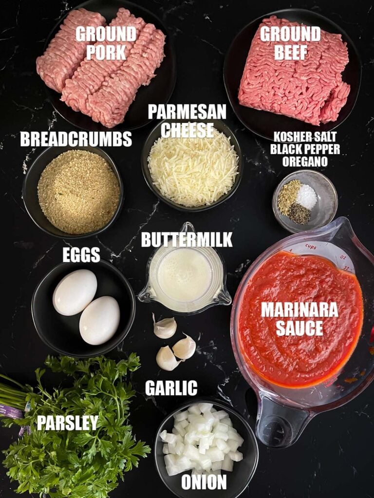 Baked parmesan meatballs recipe ingredients on a dark surface.