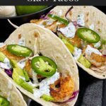 Shrimp tacos served with slaw, jalapeños, and fresh vegetables arranged for a taco-night spread.