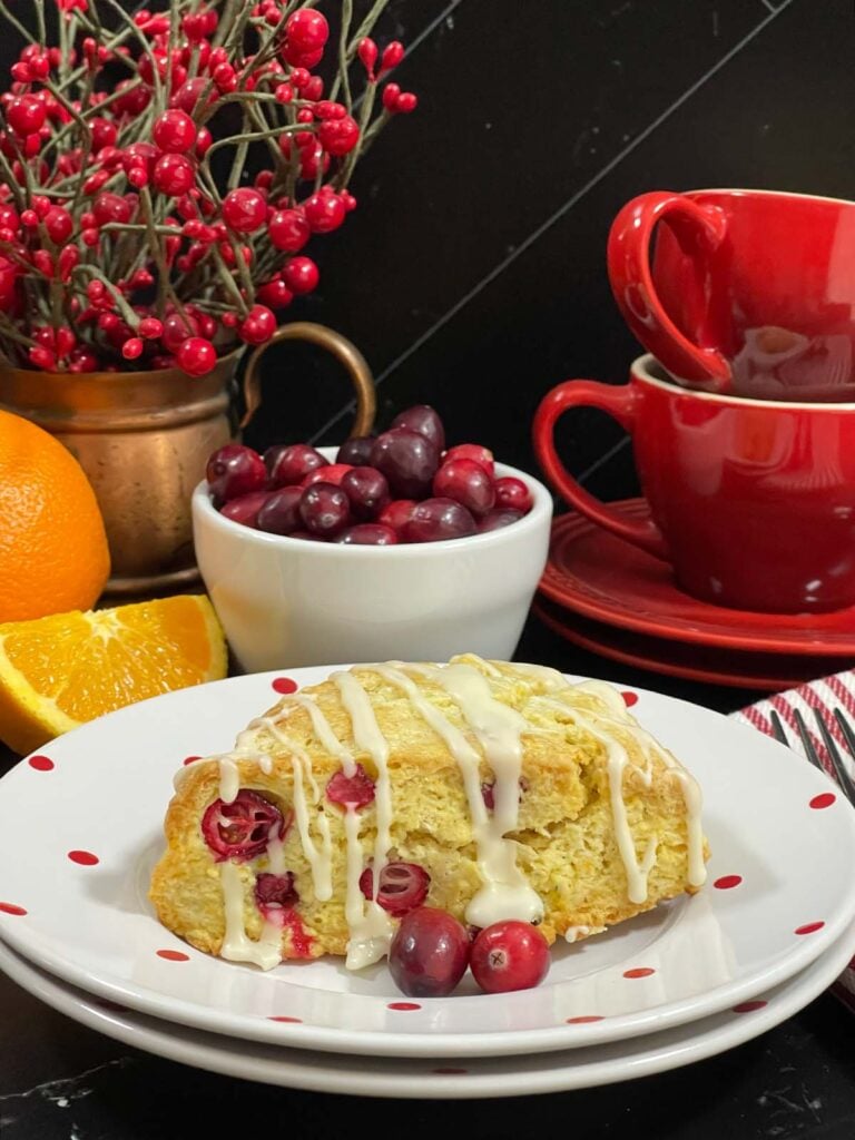 A cranberry orange scone on a light plate.