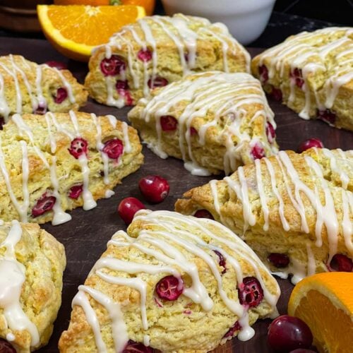 Cranberry orange scones on a wooden board.