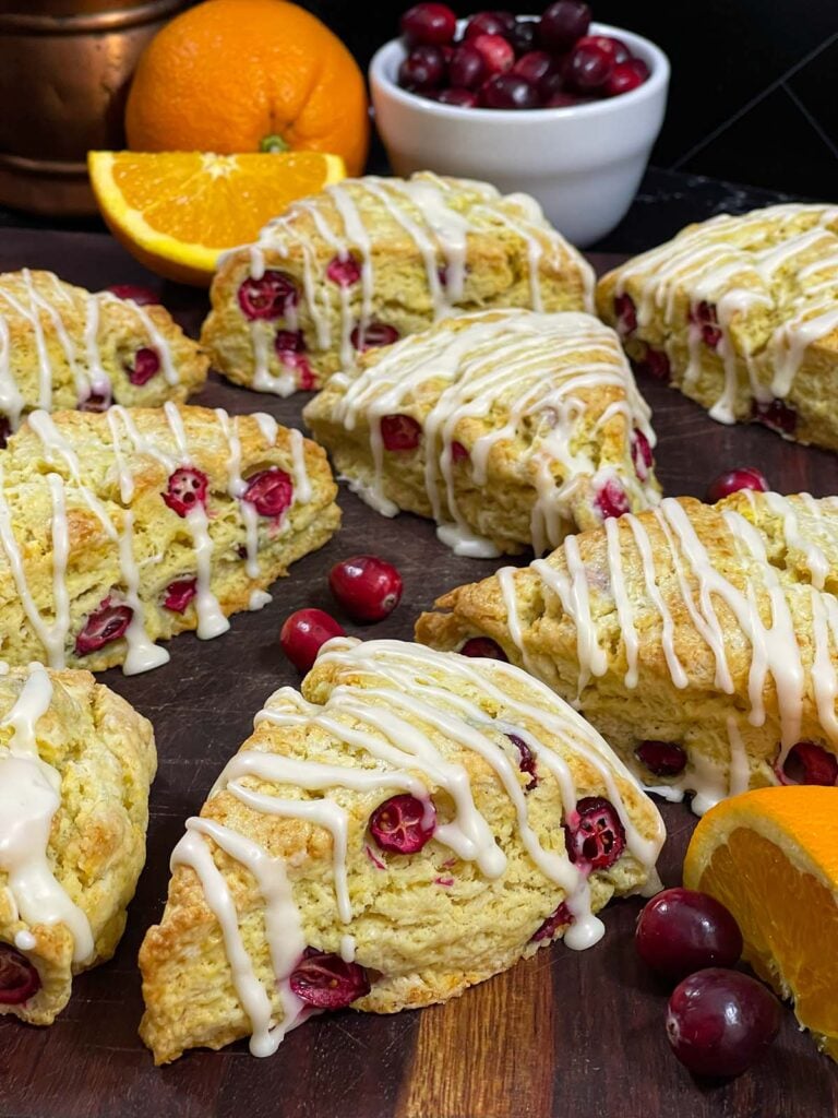 Cranberry orange scones on a wooden board.