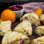 Cranberry orange scones on a wooden board.