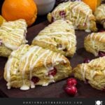Cranberry orange scones on a wooden board.