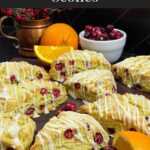 Cranberry orange scones on a wooden board.