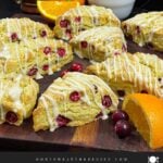 Cranberry orange scones on a wooden board.