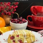 A cranberry orange scone on a light plate.