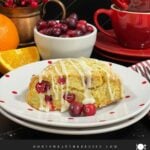 A cranberry orange scone on a light plate.