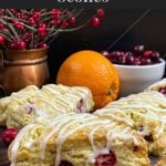 Cranberry orange scones on a wooden board.