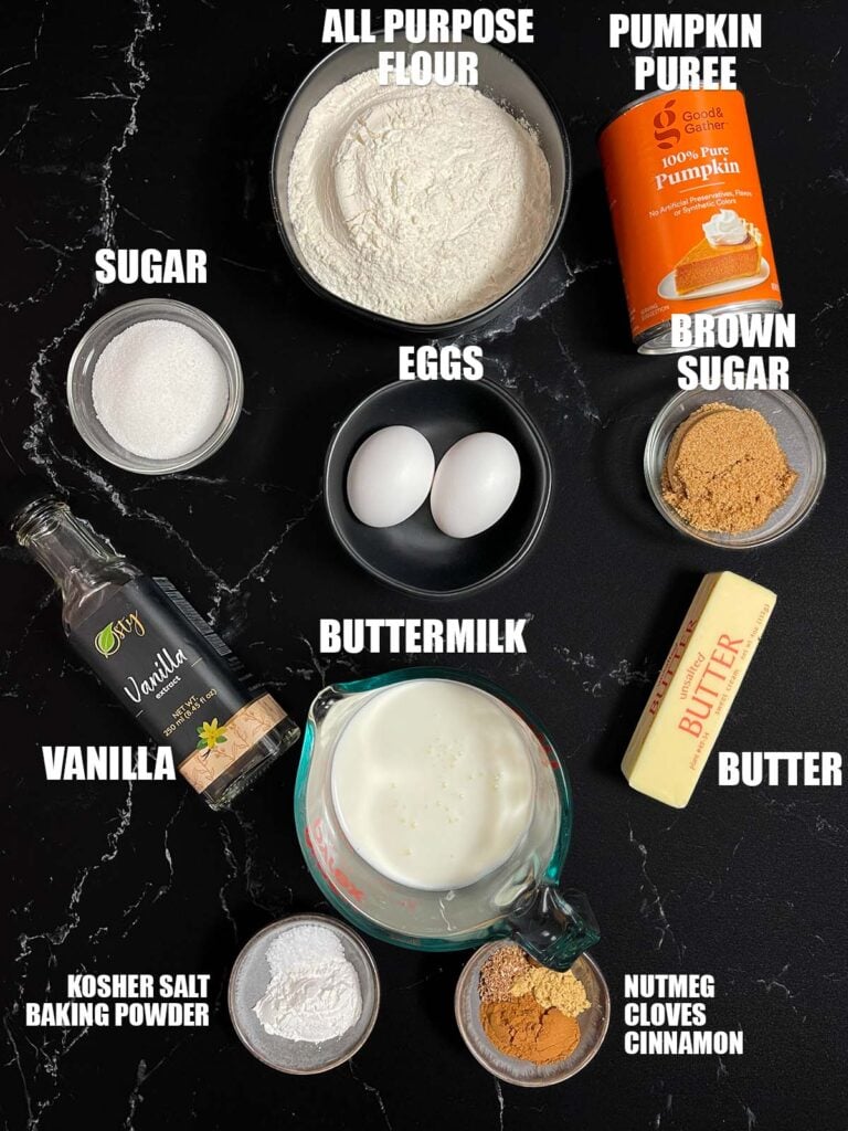 Ingredients for the pumpkin pancake recipe on a dark surface.