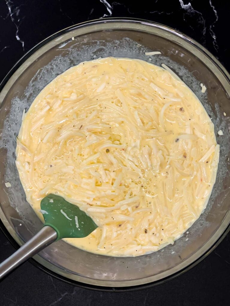 Egg, hash browns, and cheese mixture stirred together until evenly combined