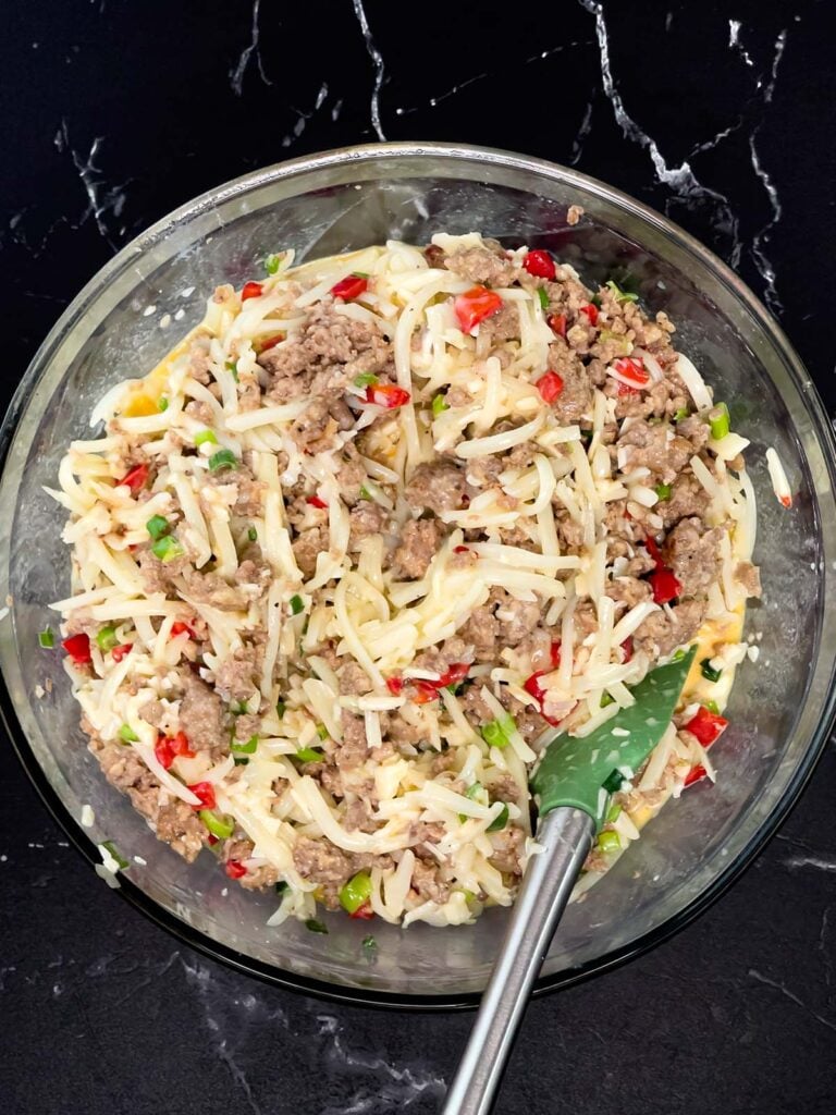 Sausage, eggs, hash browns, and cheese mixture fully combined in large mixing bowl.