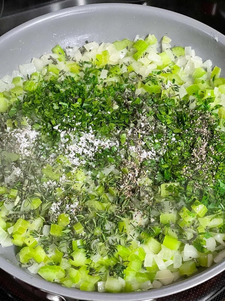 Sweated onion and celery in a skillet with fresh parsley, sage, and thyme just added.