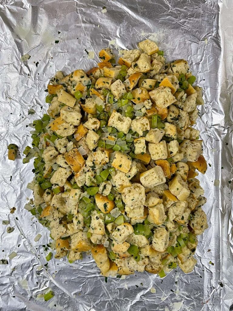 Stuffing shaped into a tight square on a foil-lined baking sheet.