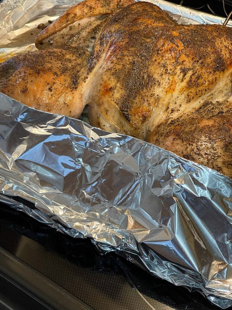 Turkey legs and exposed stuffing covered with foil to prevent over-browning.