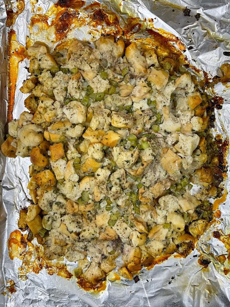 Stuffing exposed on the baking sheet after removing the turkey.