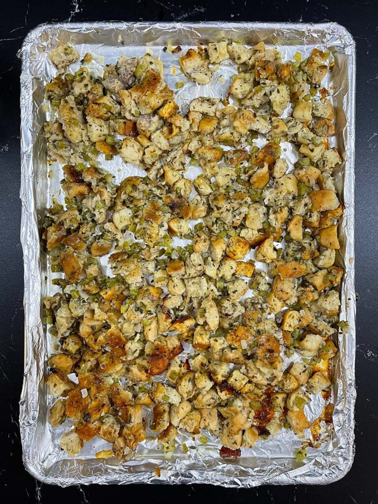 Stuffing spread out on a baking sheet to crisp in the oven.