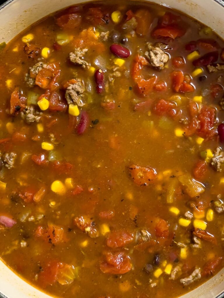 Taco soup cooking in a dutch oven.