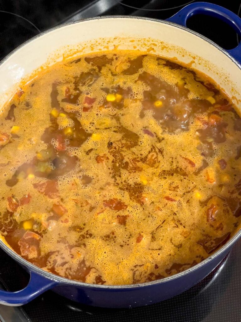 Taco soup cooking in a dutch oven.