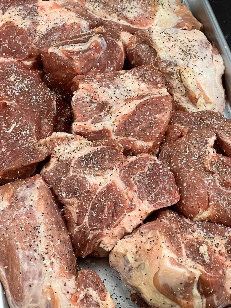 Seasoned pork shoulder, cut up in large pieces.
