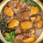 Apple cider braised pork shoulder in a dutch oven.