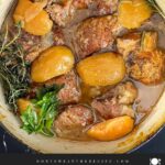 Apple cider braised pork shoulder in a dutch oven.