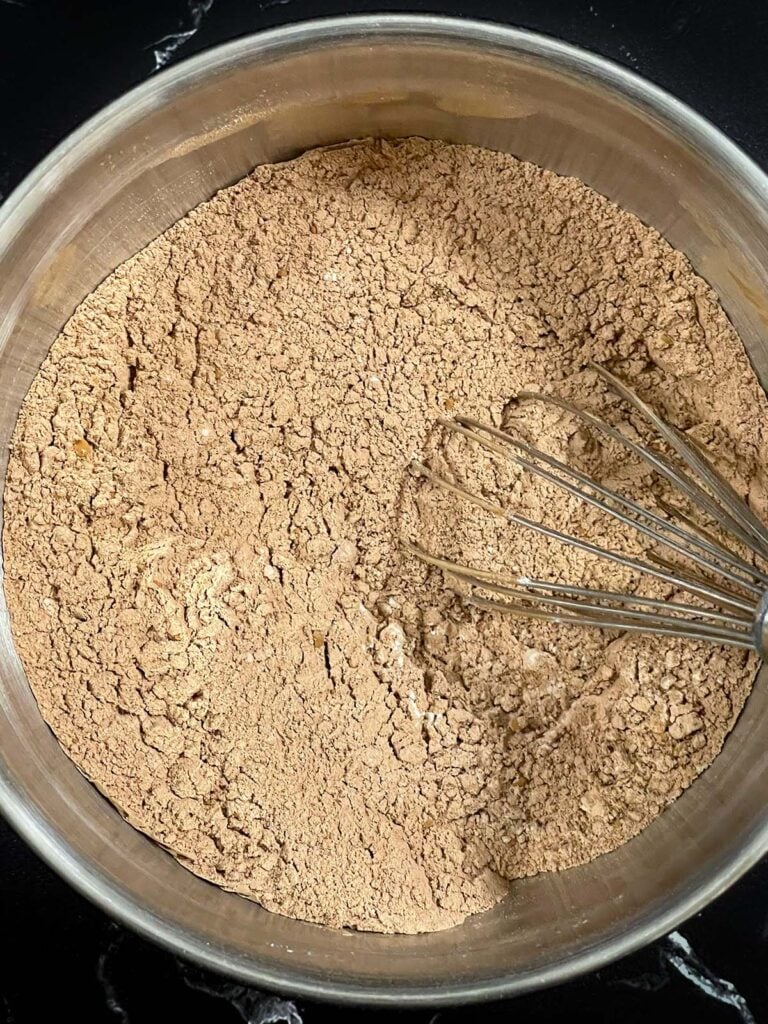 Chocolate peppermint biscotti recipe dry ingredients combined in a metal bowl.