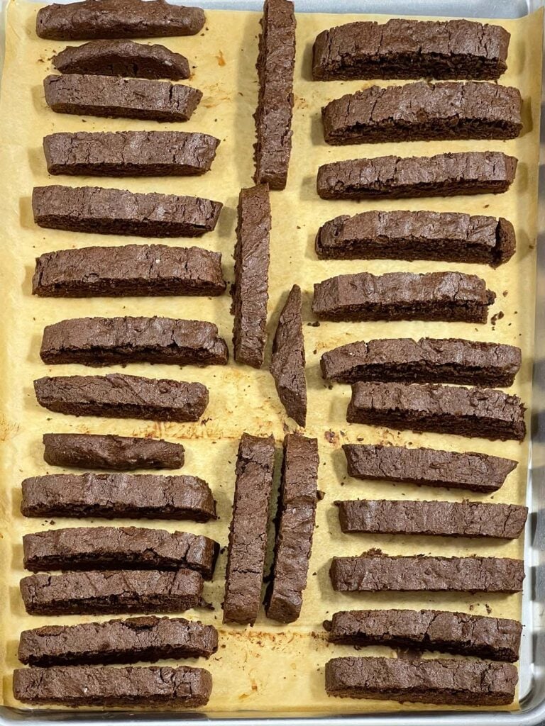 Slice chocolate peppermint biscotti placed on the prepared baking sheet.