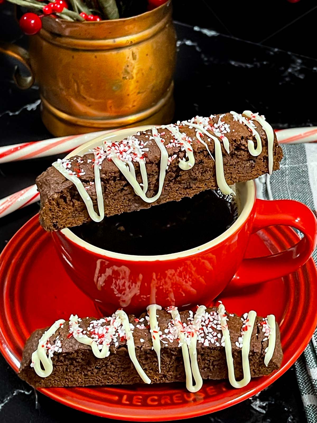 Chocolate peppermint biscotti on a red cup and saucer.
